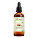 Pistachenoten olie 100 ml van Aza Natural, fles van donker glas met pipet en een etiket met een mandje pistachenoten
